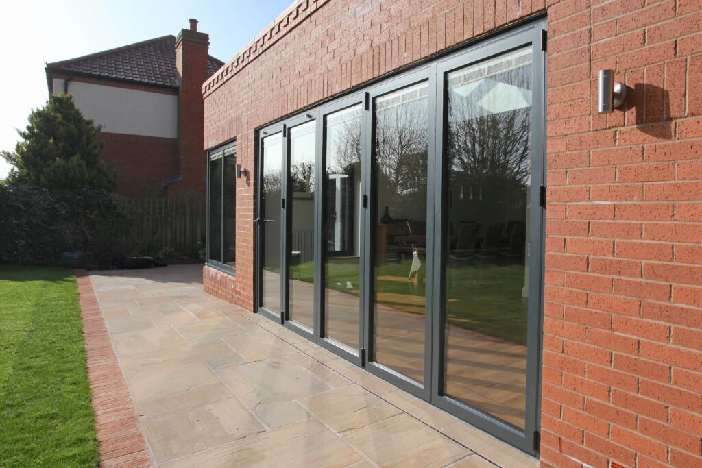 Alutech BF73 bifolding doors fitted in a new brick extension