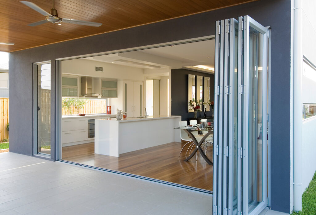 best glass for bifold doors showing a fully open bifold door set in a kitchen